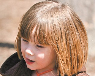 Emma Haase runs through the playground with her plastic eggs.