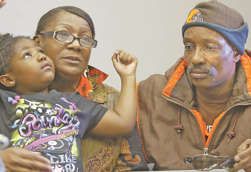 Wanda Greer holds her 5-year-old granddaughter, Amaya Greer, while seated next to her husband, Bill. The Greers’ youngest son, Brian, was shot to death Monday on the North Side. Amaya is one of Brian’s five children.