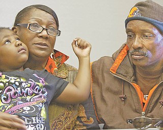 Wanda Greer holds her 5-year-old granddaughter, Amaya Greer, while seated next to her husband, Bill. The Greers’ youngest son, Brian, was shot to death Monday on the North Side. Amaya is one of Brian’s five children.