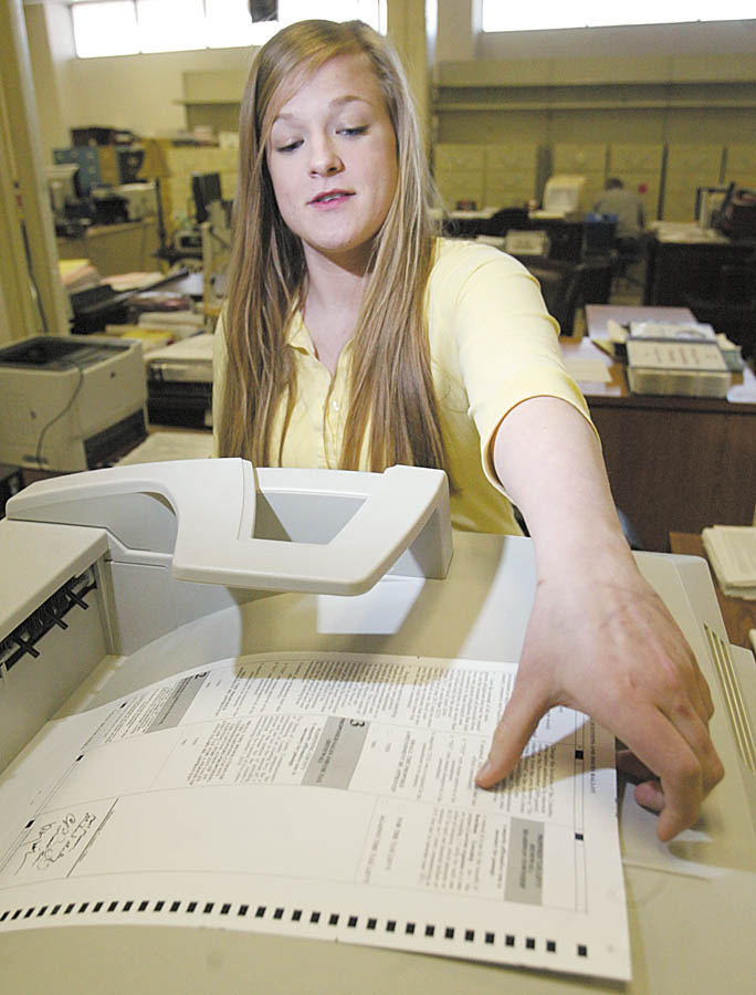 Veronica Skowron, a Mahoning County Board of Elections employee, prints a paper ballot to be used by a voter at the board office on Market Street in Youngstown. Those wanting to vote early in the May 4 primary can do so now.