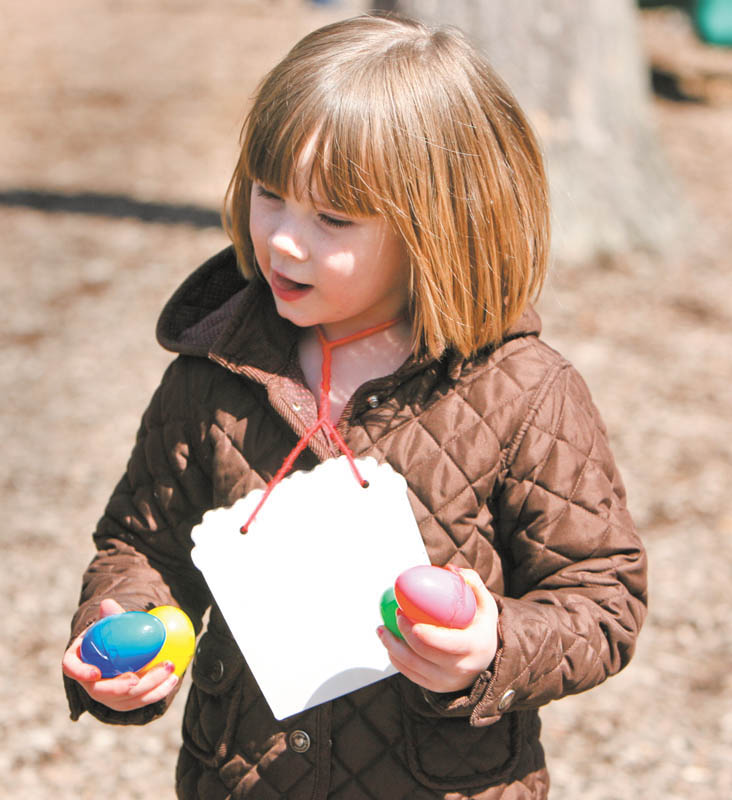 Emma Haase runs through the playground with her holiday bounty during the Easter egg hunt Tuesday sponsored by the Boardman Kiwanis for kindergarten students at Boardman schools.