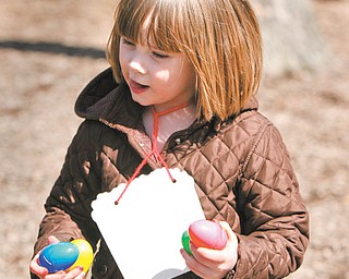 Emma Haase runs through the playground with her holiday bounty during the Easter egg hunt Tuesday sponsored by the Boardman Kiwanis for kindergarten students at Boardman schools.