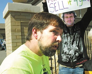 Duke Bennett of Wellsville, left, and Robert Henricksen of Struthers were among a group of Ohio Valley Tea Party
supporters who demonstrated against President Barack Obama’s health-care reform law. They gathered Tuesday at the entrance of the Youngstown Community.