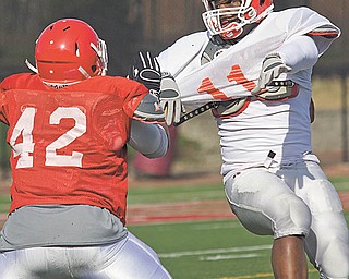 Youngstown State’s Jaimie Frasure (57) and Andy Colegrove (89) mix it up during football practice Tuesday at YSU’s Stambaugh Stadium. Head coach Eric Wolford is making his point to his team very clear during workouts: get physical or get lost.
