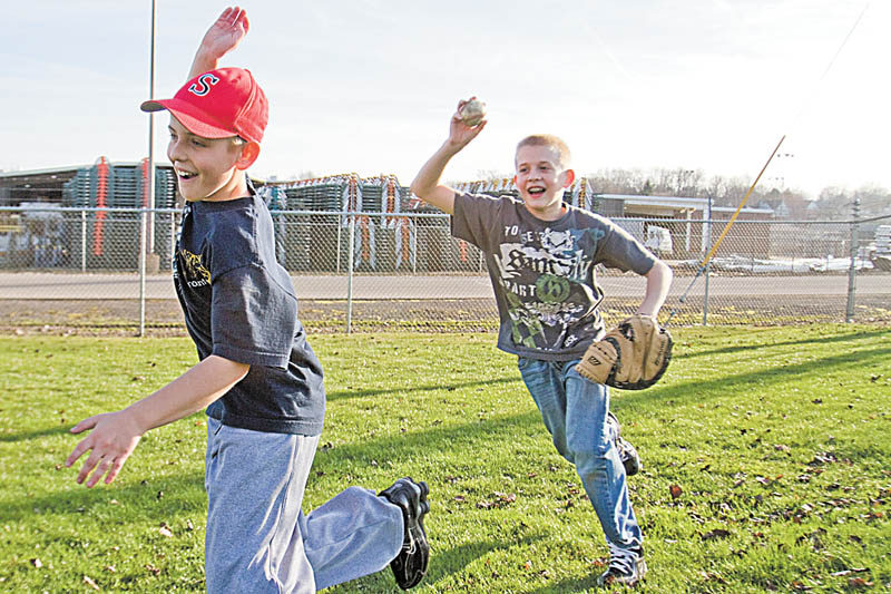 Geoffrey Hauschild|The Vindicator.Trent Stocker, 12 of Struthers, runs from Jacob Bova, 12, also of Struthers, during a game of Cheese Box outside the fields of Cene Park in Struthers on Wednesday afternoon
