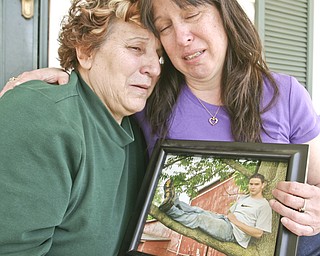 ROBERT K. YOSAY | THE VINDICATOR..Rose ( ex mother in law) and Jill (mom ) Sherbourne hold a photo of Joshua their ( son /grandson) who was killed in a pile up in Warren Twp. on his way to Cleveland to finish his induction into the Marine Corp.-30
