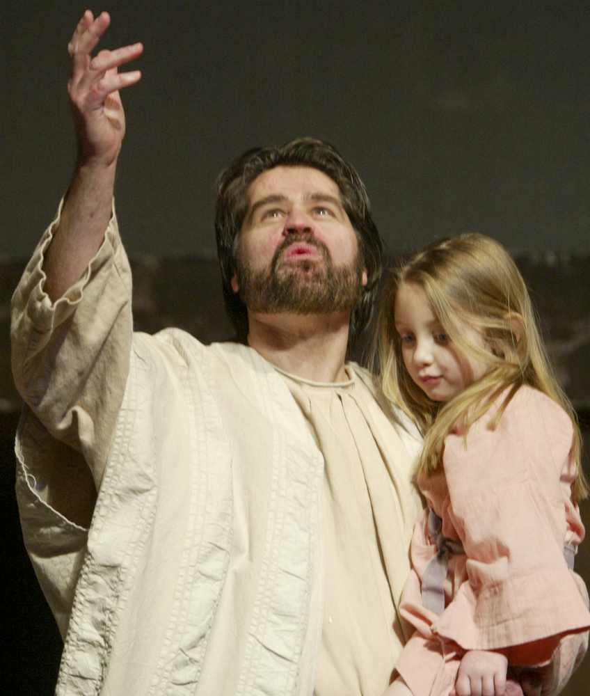 William D. Lewis|The Vindicator Jesus, portrayed by Bob Little of McDonald holds Kiersten Laing during Passion Play at Highway Tabernacle in Austintown.
