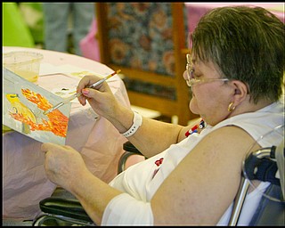 ROBERT K. YOSAY | THE VINDICATOR...Putting the finishing touches on her painting Cynthia Bondar finishes a bird - Residents of Ashley Circle at Briarfield in Austintown paint with instruction from Suzanne Gray. Now they have a little gallery, called PicassoÕs Corner, at the facility, to display their work.-30-.