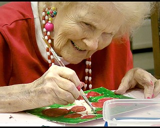 ROBERT K. YOSAY | THE VINDICATOR...Ruth Cooper works on a flower - Residents of Ashley Circle at Briarfield in Austintown paint with instruction from Suzanne Gray. Now they have a little gallery, called PicassoÕs Corner, at the facility, to display their work.-30-