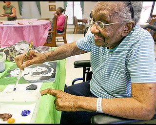 ROBERT K. YOSAY | THE VINDICATOR... Helen Bailey works on her pandas - Residents of Ashley Circle at Briarfield in Austintown paint with instruction from Suzanne Gray. Now they have a little gallery, called PicassoÕs Corner, at the facility, to display their work.-30-.