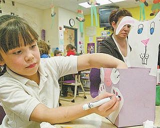 Campbell first-grader Adelanis Irizzary finishes her Easter basket during a class project earlier this week. Parents came in to all four first-grade classes and helped out.