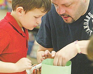 Collin Michaels gets some help from his dad, Rick Michaels, during the Easter project.