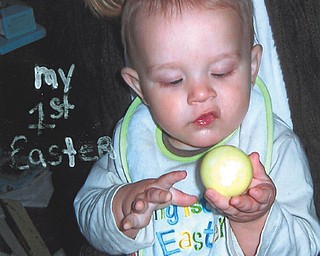 Xavier Klamer of Newton Falls inspects a colorful egg on his first Easter in 2009.