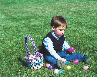 2-year-old Nicholas Rolfi is trying to find out whatÕs inside of these colorful eggs. He is the son of Tony and Janice Rolfi of St. Louis, Mo., and the grandson of Rich and Irene Makovec of Struthers..