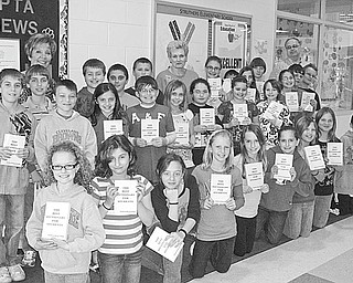 The Vindicator: Fourth-grade students at Struthers Elementary School display dictionaries given to them by Struthers Rotary Club. The books were distributed as part of the club’s literacy project, in an effort to aid students with home and school work, to build a frame of reference and to give them a better understanding of the world. The club distributed more than 300 dictionaries to fourth-graders at area schools.