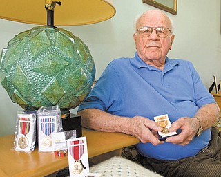 Nick Leonelli, 87, of Poland shows medals he earned serving in the Army in the Pacifi c Theater during World War II but did not receive until recently.