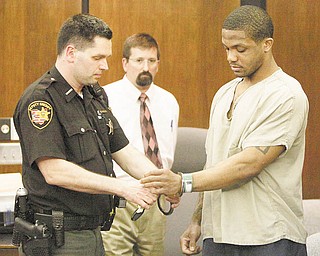 A deputy sheriff removes Maurice Clarett’s handcuff s during a courtroom hearing Wednesday in Columbus. The judge cleared the way for the former Ohio State football star to be transferred to a smaller detention facility in the city.
