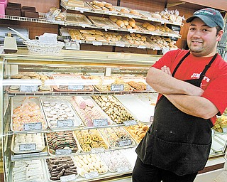 Frank Occhibove literally grew up in the aisles of Jimmy’s Italian Specialties, which his parents started in his grandfather’s garage on West Federal Street in Youngstown in 1974. Here Occhibove, manager of the store on Belmont Avenue in Liberty, stands in front of its bakery.