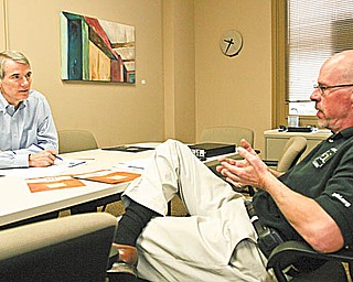 Rob Portman, left, an Ohio Republican candidate for a seat in the U.S. Senate, gets a briefing from Jim Cossler, director of the Youngstown Business Incubator, during a tour of the facility. Portman said Thursday he was impressed by what he saw and suggested the incubator should be held up as a model for other incubators across the state.