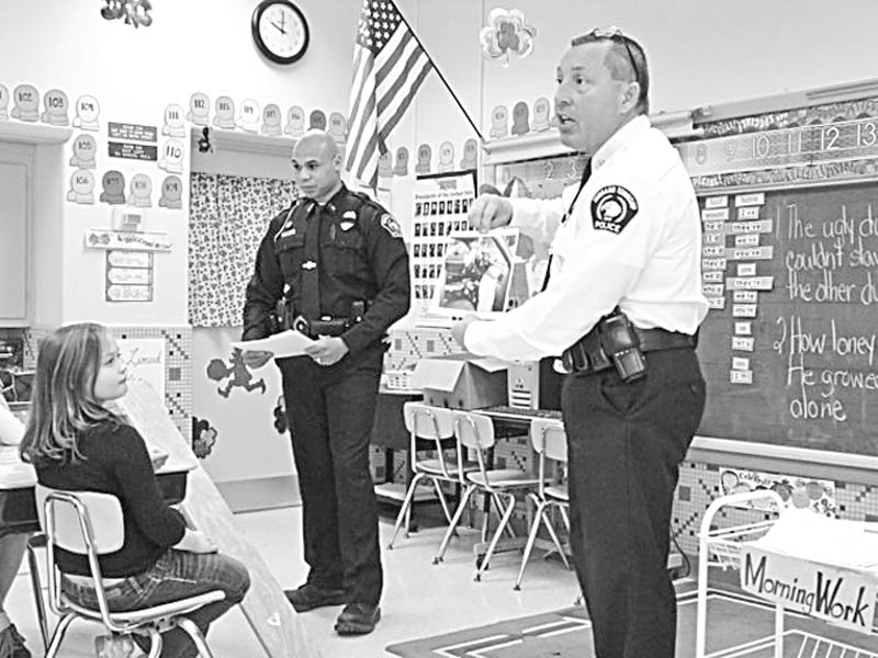 The Vindicator: 
Pupils in Mrs. Kryonvich’s third-grade class at St. Patrick School in Hubbard learned the importance of wearing seat belts recently. Encouraging the youngsters to “click it to be cool” as they stressed the importance of wearing seatbelts, Hubbard Township Police Chief Todd Coonce, right, and township Officer Courtney Perkins demonstrated what happens when there is an accident and passengers are not wearing seat belts. They also explained how air bags operate. The children watched a video featuring Bill Nye the Science Guy, and learned that the safest place to sit in a car is the back seat.