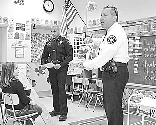 The Vindicator:
Pupils in Mrs. Kryonvich’s third-grade class at St. Patrick School in Hubbard learned the importance of wearing seat belts recently. Encouraging the youngsters to “click it to be cool” as they stressed the importance of wearing seatbelts, Hubbard Township Police Chief Todd Coonce, right, and township Officer Courtney Perkins demonstrated what happens when there is an accident and passengers are not wearing seat belts. They also explained how air bags operate. The children watched a video featuring Bill Nye the Science Guy, and learned that the safest place to sit in a car is the back seat.