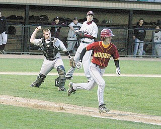 Boardman catcher Dan Popio, left, throws out Dan Reese of Cardinal Mooney at first base during Monday’s game at Cene Park.