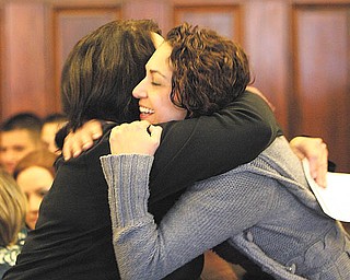 Nicolette Simkins of Meridian Services, right, gives a congratulatory hug to one of the graduates at the drug-court graduation ceremony at Mahoning County Common Pleas Court. Six people completed the requirements and graduated from the program Wednesday.