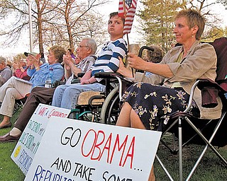 The Vindicator|Geoffrey Hauschild.Candy Davis, of Boardman, listens to speakers next to her daughter Abbey, 19, who sits in a wheelchair due to a disability during a TEA Party event on the green in Canfield on Thursday evening. "I think its important to try to improve the condition of the country and there are some good ideas," said Davis. "I don't think there is a place for the government or the employer in Health Care, I just want it to be affordable like my house insurance or car insurance."
