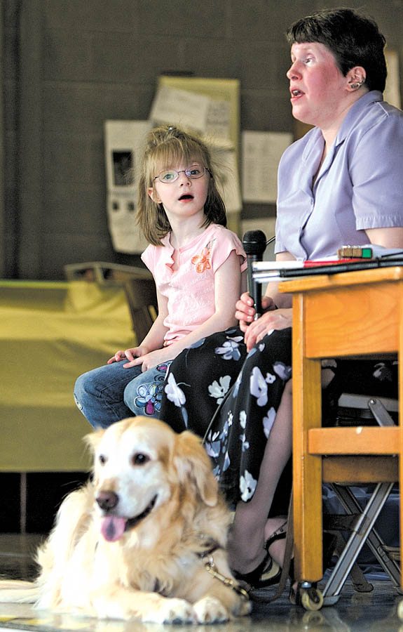 Geoffrey Hauschild|The Vindicator.Tracie Reiser speaks to students at Watson Elementary about living with a vision disability accompanied by  Faith Sylvester, 5, a student at the school who lives with impaired vision and Reiser's guide dog, Jimi, a golden retreiver, while in Austintown on Thursday afternoon.