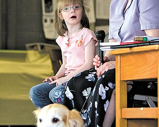 Geoffrey Hauschild|The Vindicator.Tracie Reiser speaks to students at Watson Elementary about living with a vision disability accompanied by Faith Sylvester, 5, a student at the school who lives with impaired vision and Reiser's guide dog, Jimi, a golden retreiver, while in Austintown on Thursday afternoon.