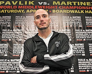 World middleweight boxing champion Kelly “The Ghost” Pavlik of Youngstown poses in front of a banner touting his upcoming title fight against WBC super welterweight champion Sergio Martinez of Argentina during Media Day on Thursday at the historic Boardwalk Hall in Atlantic City, N.J. Top Rank, in association with DiBella Entertainment and Caesars Atlantic City, is promoting Saturday’s fight, which will air on HBO World Championship Boxing.