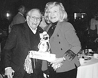 No place like home: Although they now live in Ellenton, Fla., Tee and Trish Ross, formerly of Struthers, show they are still Penguin fans by displaying a centerpiece from their table at the annual Youngstown Alumni Day in Sarasota, Fla. Their recent book, “It’s a Great Life at Any Age,” was featured at the luncheon, where Dr. David Sweet presented a summary of his 10 years as president at Youngstown State University.