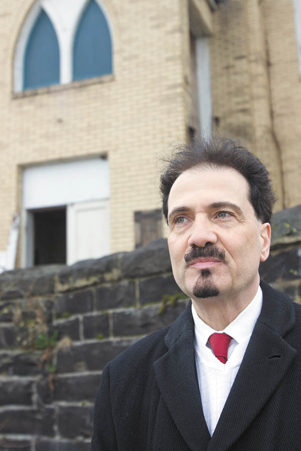 Richard Scarsella, historic-preservation promoter, is the man behind Sacred Places Dialogue, a movement
about preserving or re-inventing places of worship. He’s standing in front of the closed St. Mary’s Byzantine
Church on Salt Springs Road, Youngstown, which has housed various congregations. An individual now owns
the building, which is in disrepair.