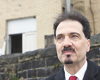 Richard Scarsella, historic-preservation promoter, is the man behind Sacred Places Dialogue, a movement
about preserving or re-inventing places of worship. He’s standing in front of the closed St. Mary’s Byzantine
Church on Salt Springs Road, Youngstown, which has housed various congregations. An individual now owns
the building, which is in disrepair.