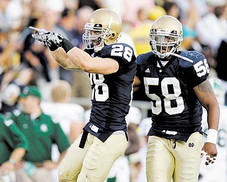 Notre Dame safety Kyle McCarthy, left, celebrates a last-minute interception in front of teammate Brian Smith during a September game in South Bend, Ind.