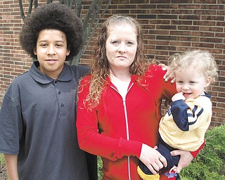 Nicole Binion of Warren stands with her 13-year-old son Marquise, .left, and her 21-month-old son Eli'jah outside of St. Demetrios .Banquet Hall in Warren, where Nicole was honored for Rising Up and .Moving On from a past that included drug addiction and prostitution .to regain custody of Eli'jah and re-establish her relationship with .Marquise.