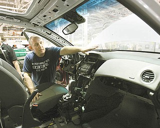 Austintown, a launch team member, points out the 10 airbags inside the Cruze. The airbags are deployed 
by sensors that also alert OnStar and Automatic Crash Response in the event of a collision. The cooperation between management and workers is unprecedented at the Lordstown plant, Aeppli said.
