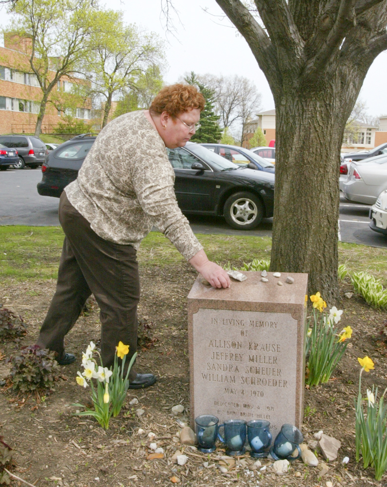 Jane Doughton, a Valley resident who was a student at Kent State on May 4, 1970 when 4 students were killed by Ohio National Guard gunfire, places a stone on a memorial to the 4 students.