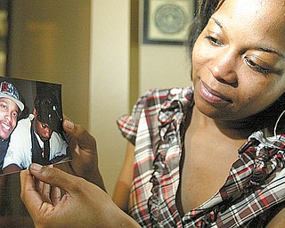 Latisha Weaver, 24, holds a photo of her brother, Elijah Paige, 20, who died Saturday in a car accident. She reflected at their home on Blackburn Street in Campbell on Monday on his life and the wait endured by the family in making a positive identification.