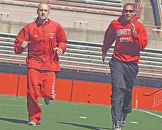 Adam Kagarise and Tarelle Irwin run during practice at Stambaugh Stadium.
