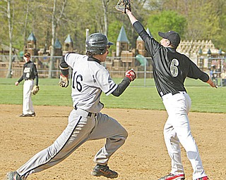 Howland’s Nick Marino is out at fi rst as Harding’s Will Frazier makes the catch in the second inning of Wednesday’s game at Howland.