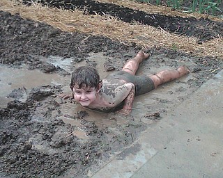 Angelo Caruso, 4, of Cuyahoga Falls is enjoying the first mud of spring. His parents grew up in the Mahoning Valley and his grandparents live in Poland and Boardman.