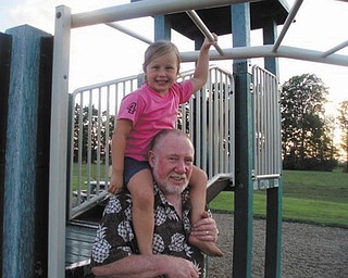 Enjoying spring in the park are Madalyn Smith 6, and her grandpa, Jerry Hoover.