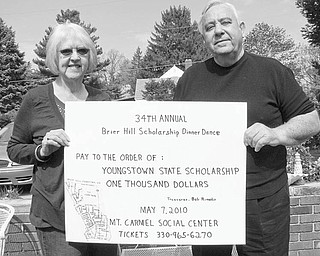 The 34th annual Brier Hill Scholarship Dinner and Dance will be Friday at Mount Carmel Social Hall, 343 Via Mount Carmel. Doors open at 5:30; dinner will be at 6. The sign displayed above by Kathy Rimedio, scholarship chairwoman, and Ray Greco, committee president, informs the public that a $1,000 scholarship check will be presented to a Youngstown State University student at the event. Cost for the evening is $25. Tickets can be purchased until Monday by calling Bob Rimedio, (330) 965-6270, or Anthony Julian, (330) 799-8184.