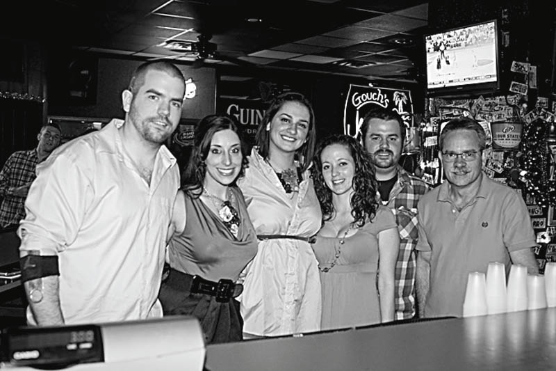 The FrockOn LLC, a fashion social networking site, teamed up with Slim’s Bar and Grille, 2844 Market St., to present an evening of live music, fashions and blue drink specials April 3 as a benefit for the Rescue Mission. Working together to make the “Chasing the Blues” event a success are members of FrockOn, shown above as they pose with the grille owners . 