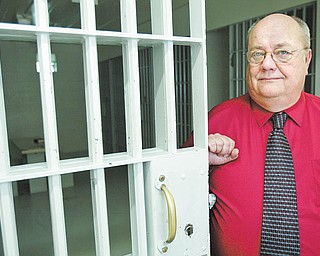 Bob Norris, 59, longtime Struthers police chief, stands near the city jail cell. He retires at the end of this month, ending a law-enforcement career that began in 1975.