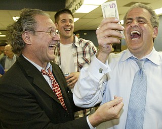 William D LewisThe Vindicator Bob Hagan gives Dave Betras 5$ Betras said the Mahoning County Dem Party is broke but its back. Hagan said he'd donate the first $5. Victory party at Mahoning Plaza Tuesday.