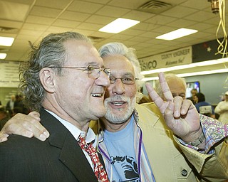 William D Lewis The vindicator Bob Hagan celebrates with YSUprofessorDr. Gabriel Palmer-Fernandez during Dem party at Mahoning Plaza in Ytown tuesday.