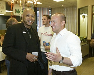 William D Lewis The Vindicator Joe Schiavoni, right, talks with Rev Kenneth simon, pastor of New Bethel Church during party at Mahoning Plaza tuesday night.