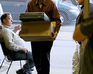 ROBERT K. YOSAY |THE VINDICATOR . Sam Lordi of the Mahoning County Election Board Staff carrys in the first of many machines used in Tuesday Elections - 30-